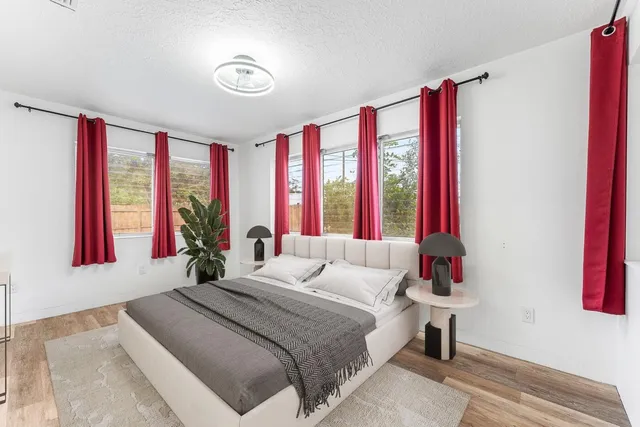 a bedroom with a bed and a large window