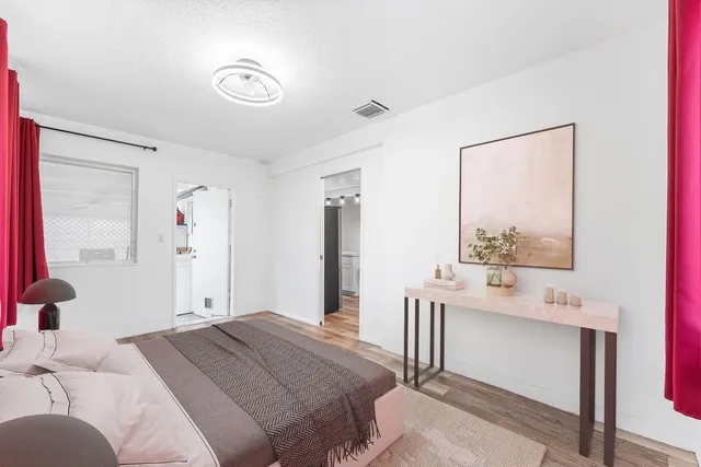 a bedroom with a bed and a window