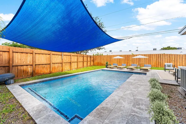 a view of swimming pool with outdoor seating