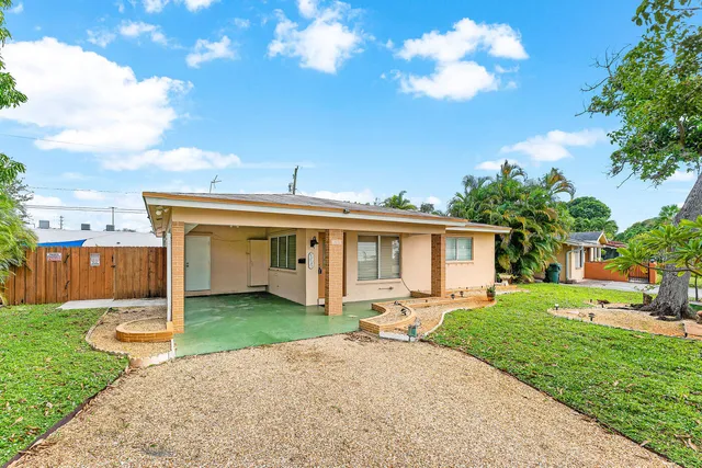 a view of a house with yard and a garden