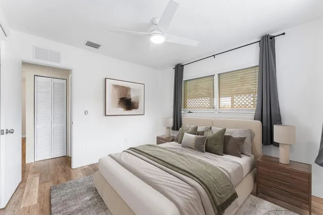 a bedroom with a large bed and a window