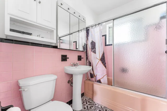 a bathroom with a sink toilet and shower
