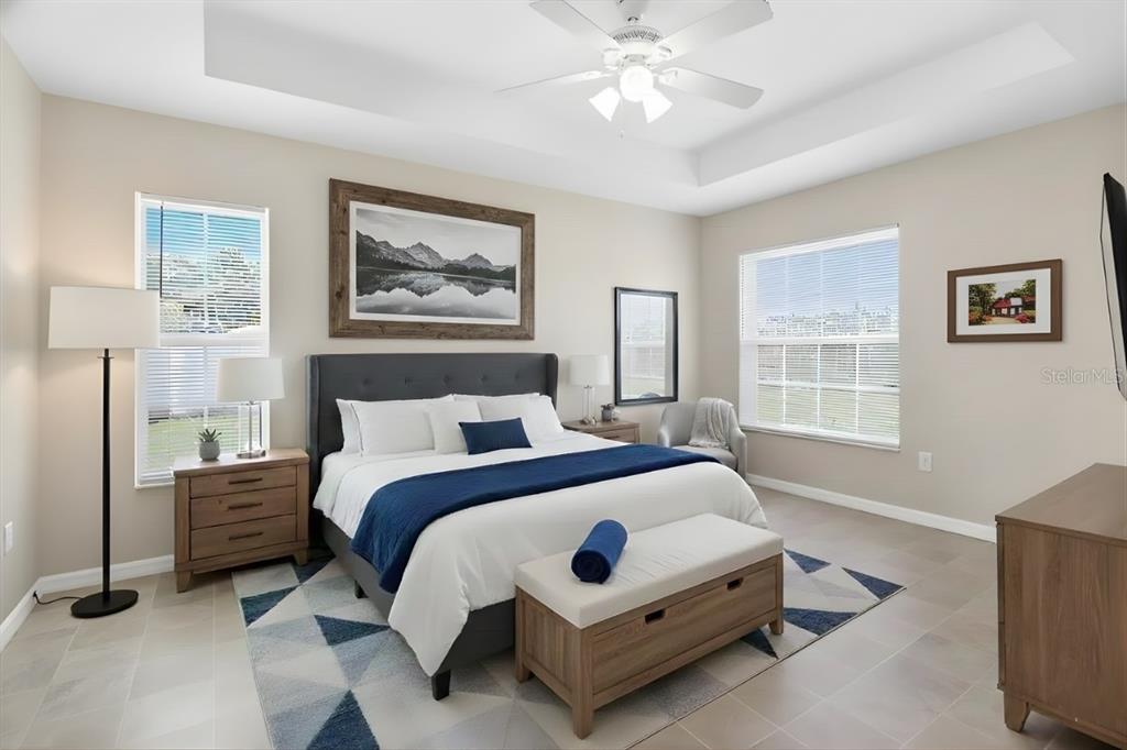 1 Pecan Course Circle Ocala, FL 34472 - Photo 8 of 24 a spacious bedroom with a bed lamp and a window