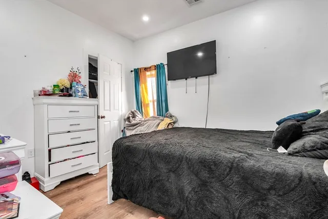 a bedroom with a bed and a flat screen tv