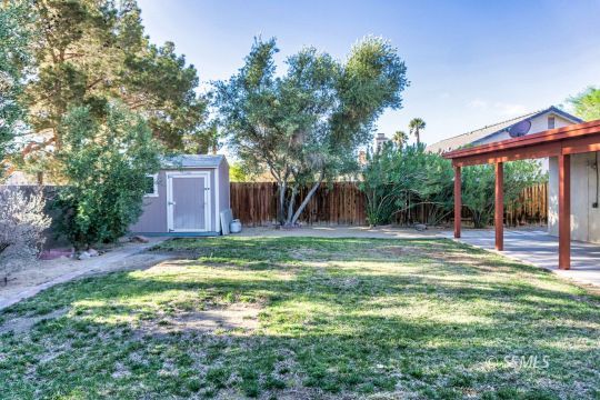 512 Amanda Street Ridgecrest, CA 93555 - Photo 43 of 44 a backyard of a house with table and chairs