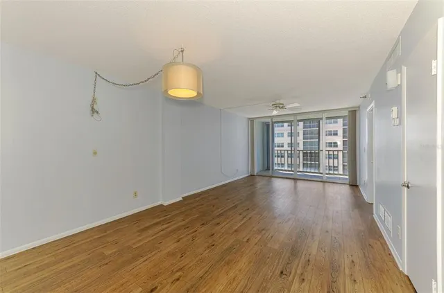 a living room with furniture a chandelier and a flat screen tv