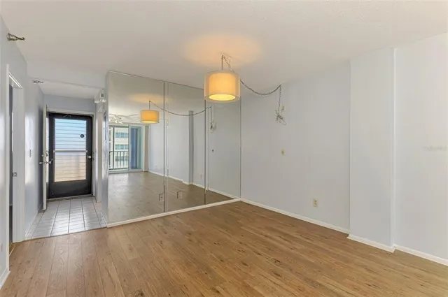 a view of a big room with wooden floor and windows