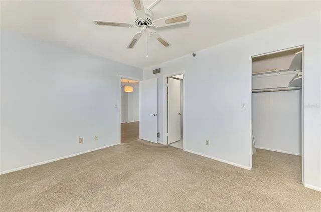 a white toilet sitting next to a shower