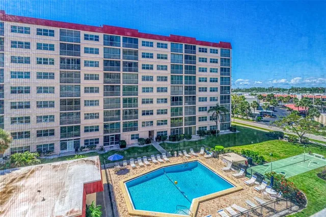 a view of swimming pool with outdoor seating and plants