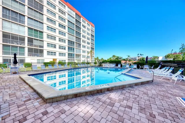 a view of a swimming pool with a lounge chairs