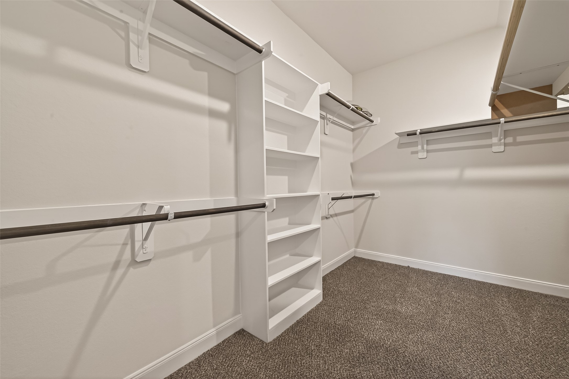 4231 Reese Ravine Lane Katy, TX 77493 - Photo 14 of 32 What a closet! The primary bedroom walk-in closet offers lots of space!