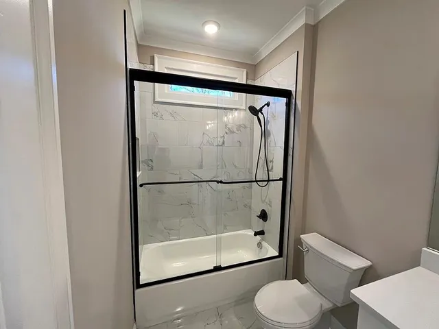 a bathroom with a glass shower door