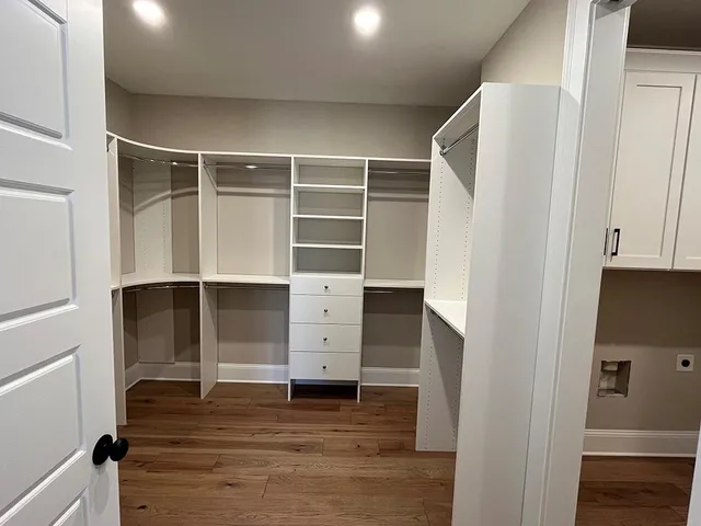 a view of walk in closet with empty racks