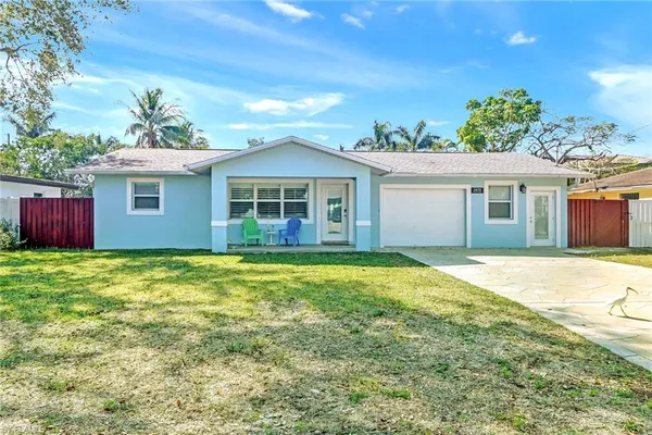 a view of a house with a backyard