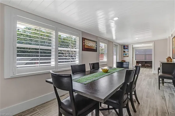 a view of a dining room with furniture and window