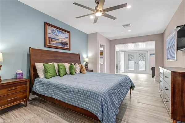 a bedroom with a bed and wooden floor