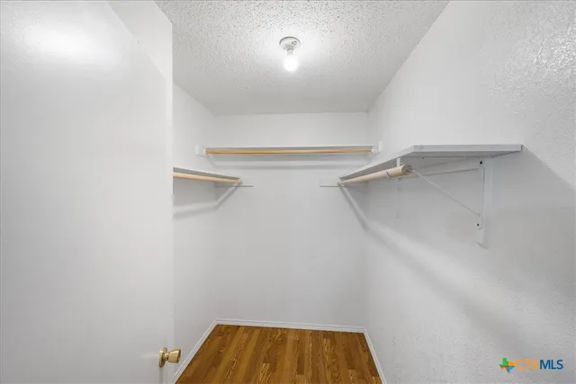 a view of a room with shelf on the wall