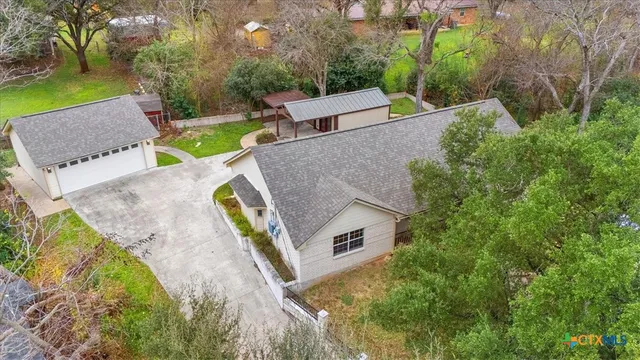 an aerial view of a house with garden space and street view
