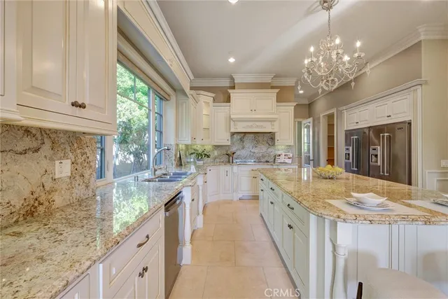 a living room with furniture chandelier and a large window