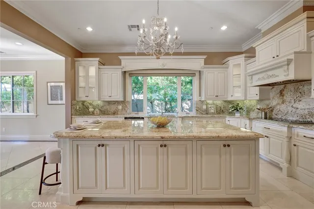 a living room with fireplace furniture and a large window