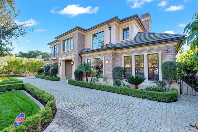 a front view of a house with garden and porch