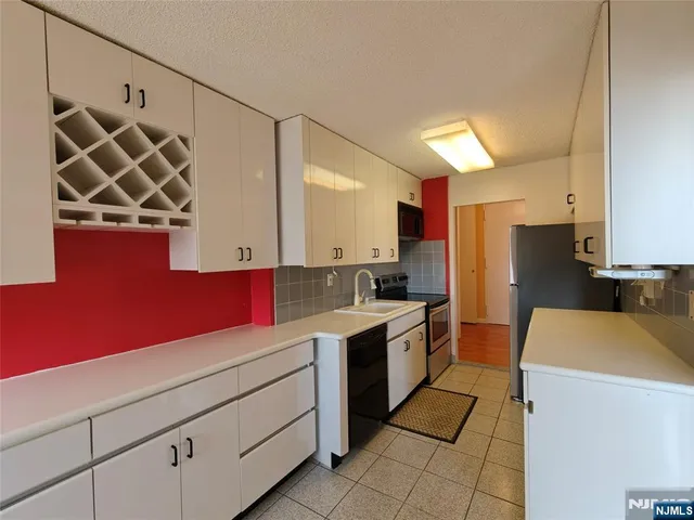 a kitchen with a sink dishwasher stove and refrigerator