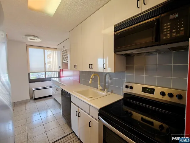 a kitchen with a stove and a microwave