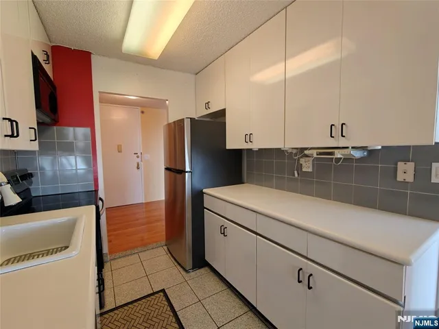 a kitchen with a refrigerator and a sink