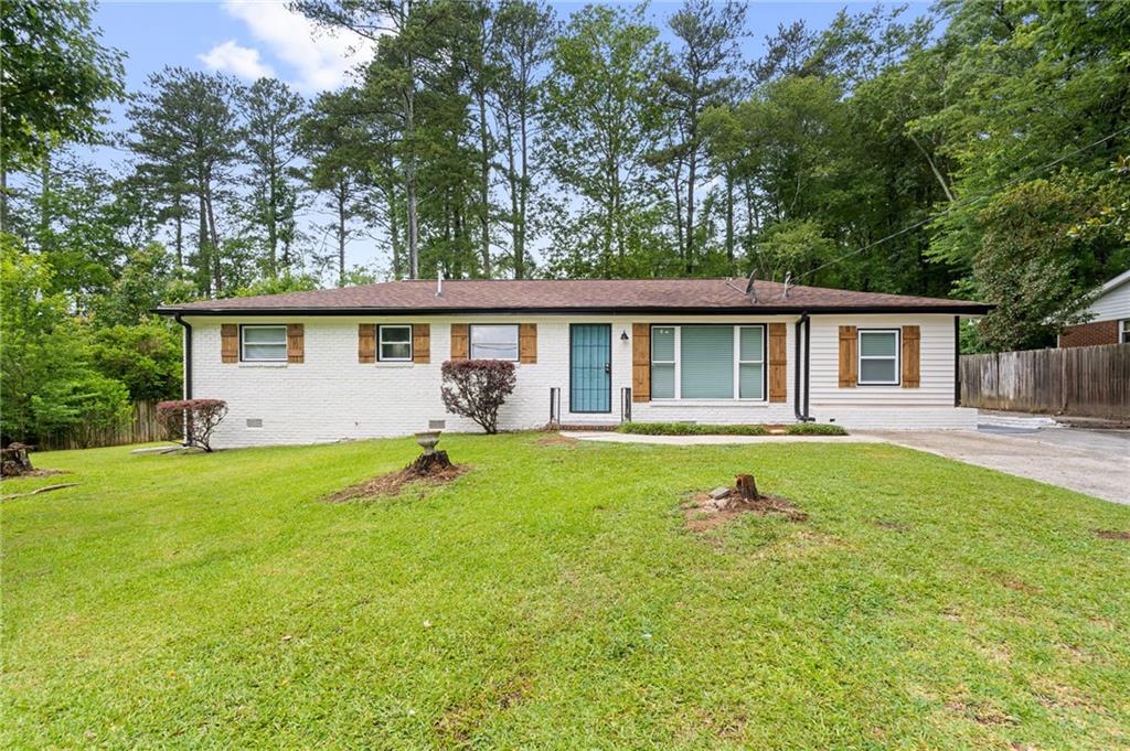 a front view of house with yard and green space