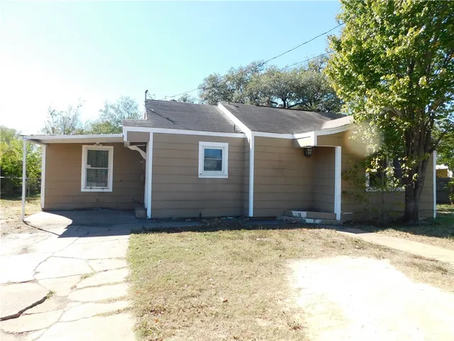 a front view of house with yard outdoor seating and barbeque oven