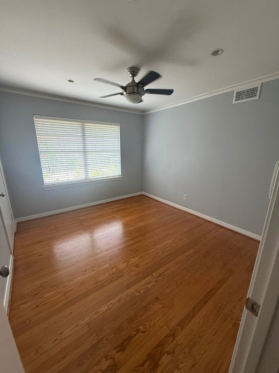 4114 Norfolk Street Houston, TX 77027 - Photo 5 of 7 a view of empty room with wooden floor and fan