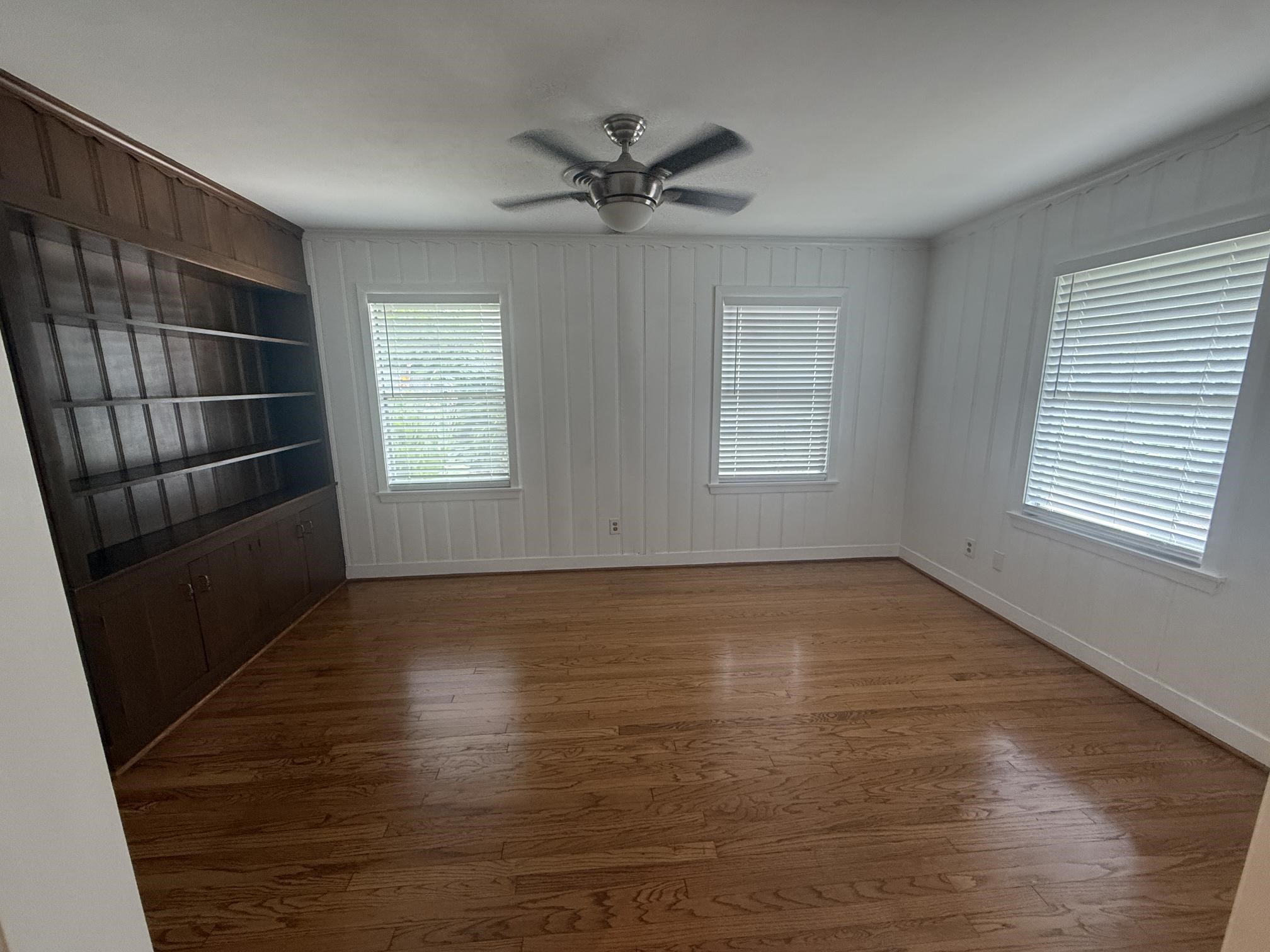 4114 Norfolk Street Houston, TX 77027 - Photo 7 of 7 a view of an empty room with a window and wooden floor