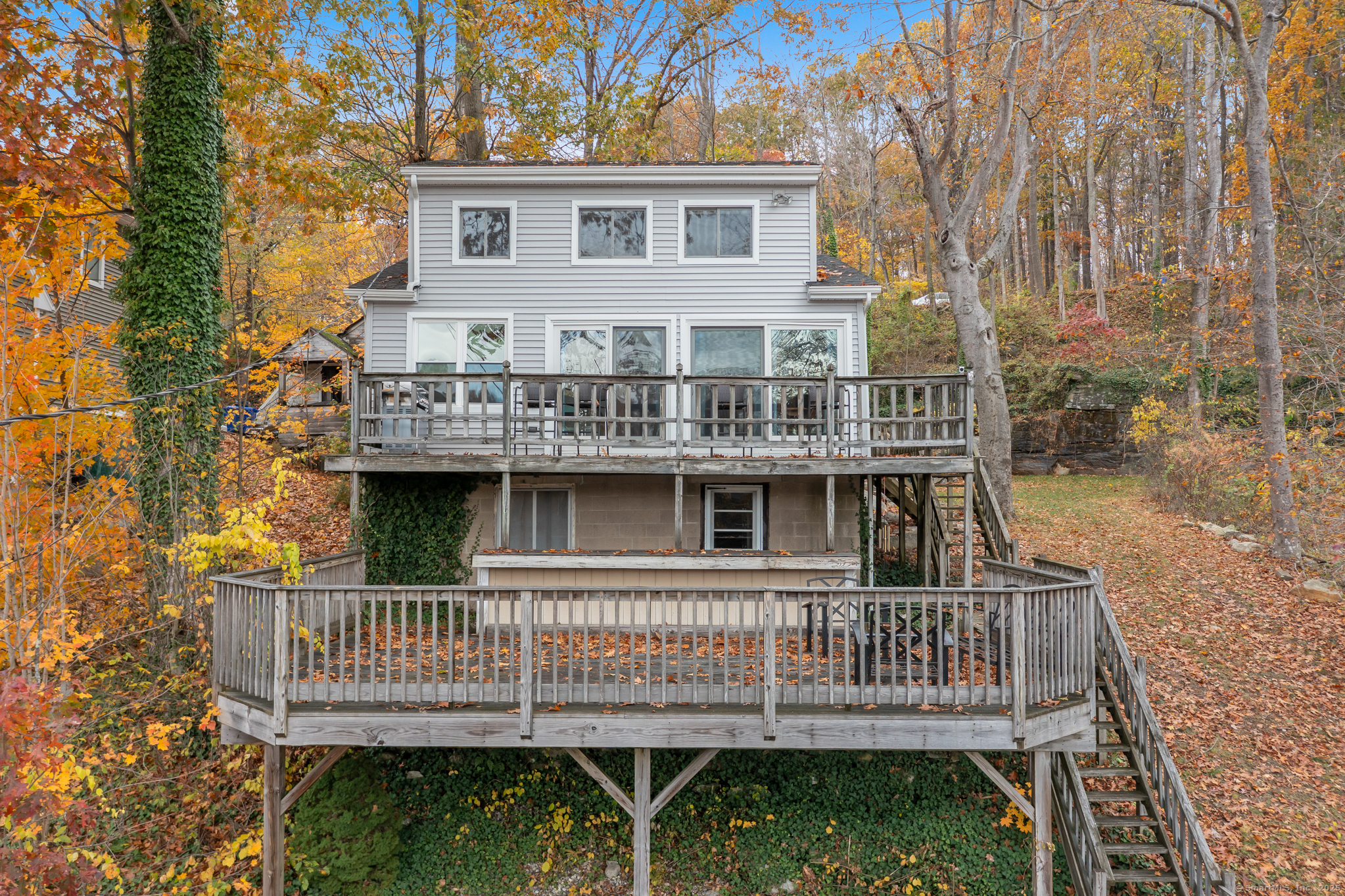 a view of a house with a deck and furniture