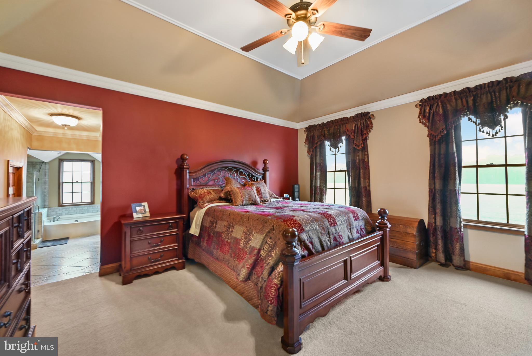 1495 Midstate Road Felton, DE 19943 - Photo 15 of 25 a spacious bedroom with a bed and a chandelier