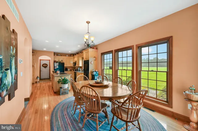 a dining room with furniture window and wooden floor