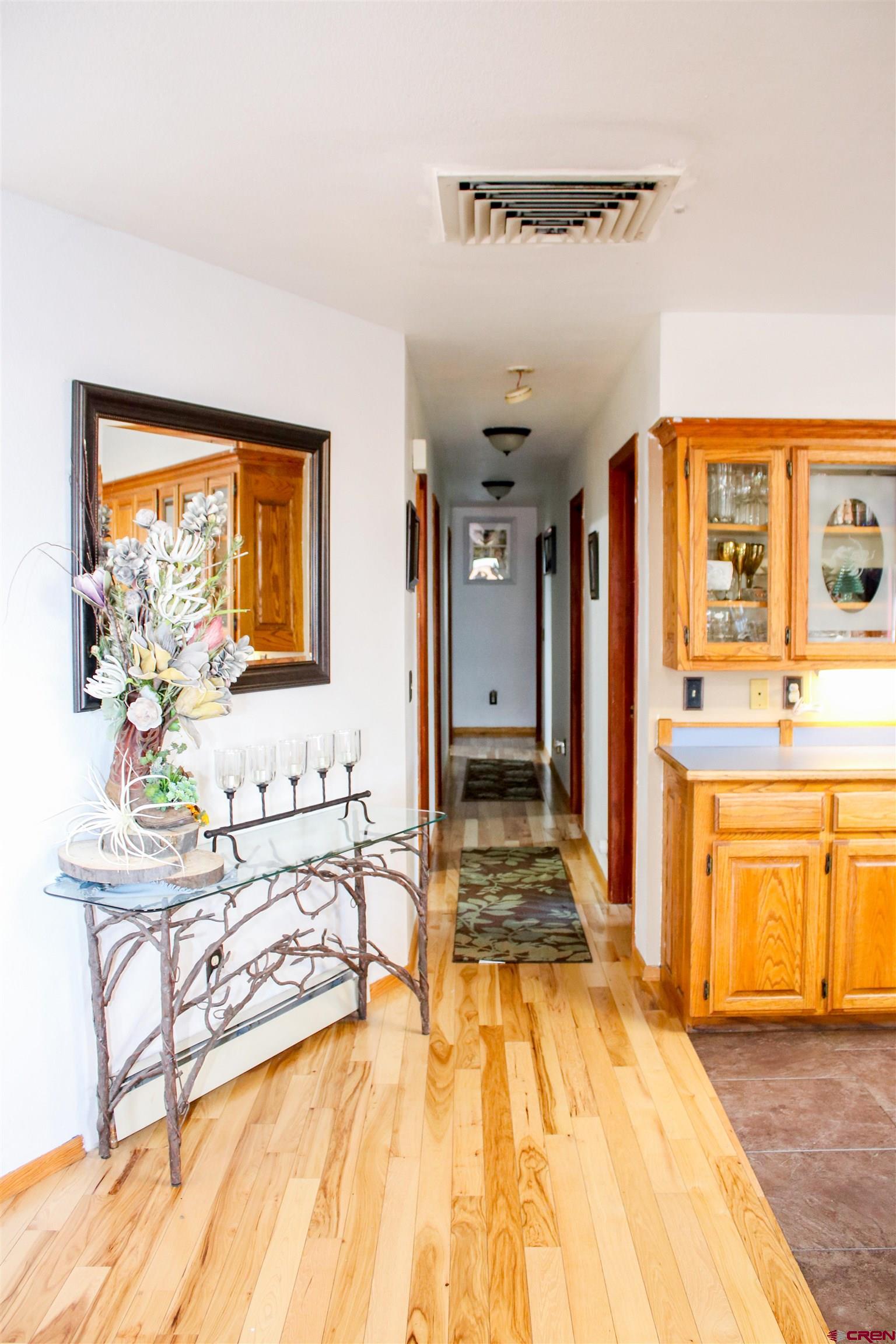 58811 Banner Road Olathe, CO 81425 - Photo 15 of 35 a spacious bedroom with a large bed a table and chair