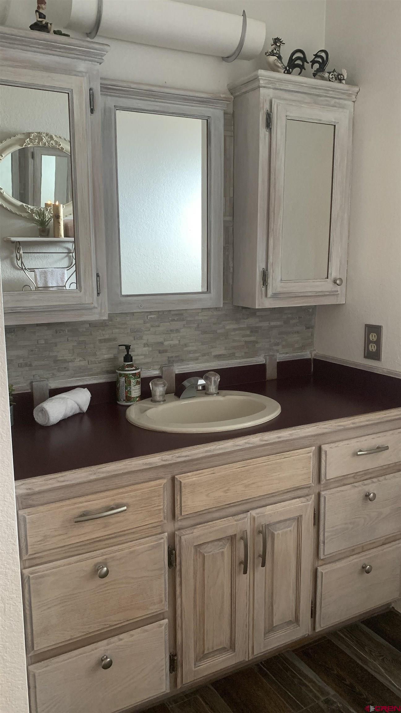 58811 Banner Road Olathe, CO 81425 - Photo 17 of 35 a view of a sink a mirror and cabinets