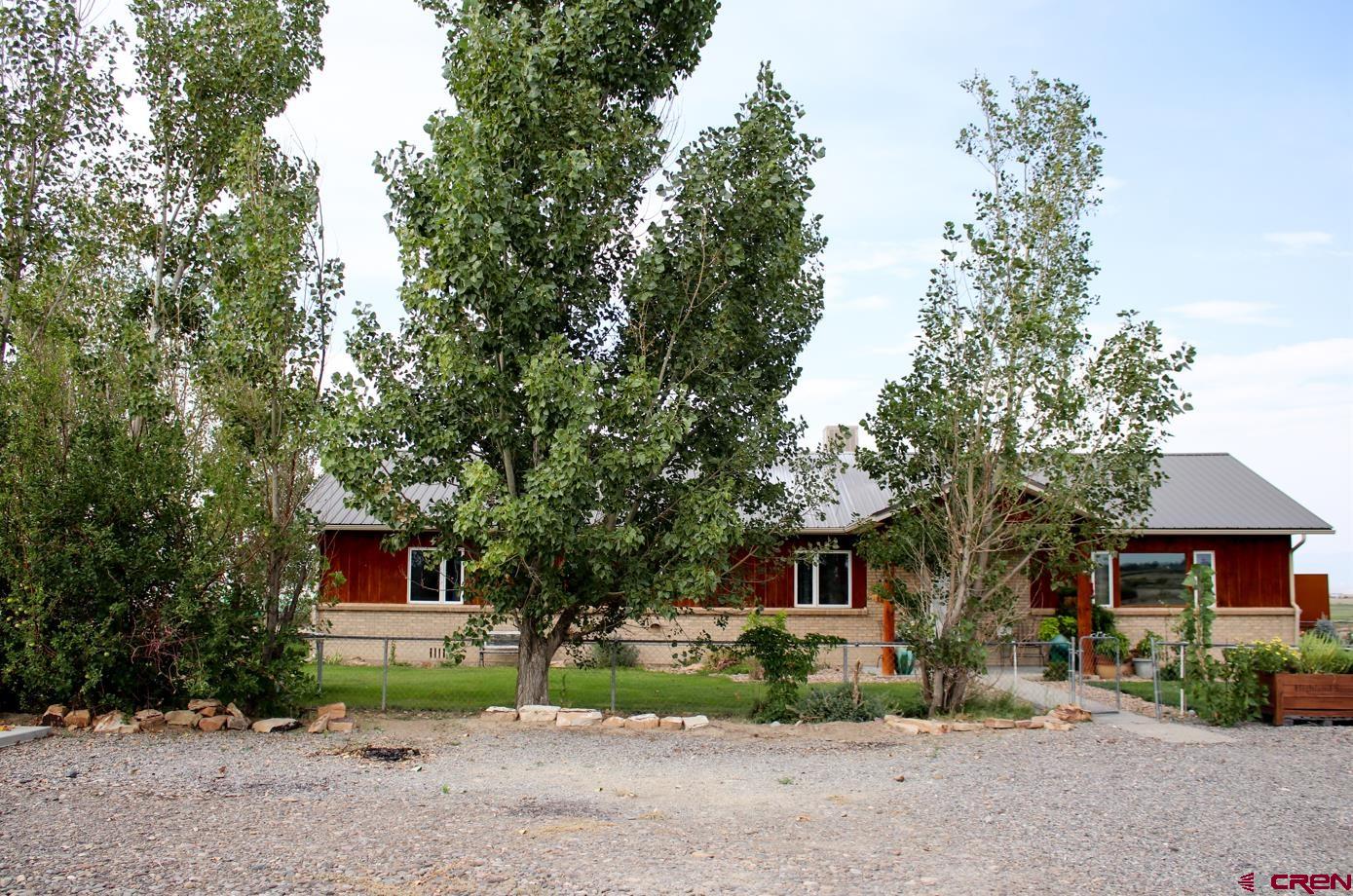 58811 Banner Road Olathe, CO 81425 - Photo 2 of 35 a front view of a house with a yard and trees