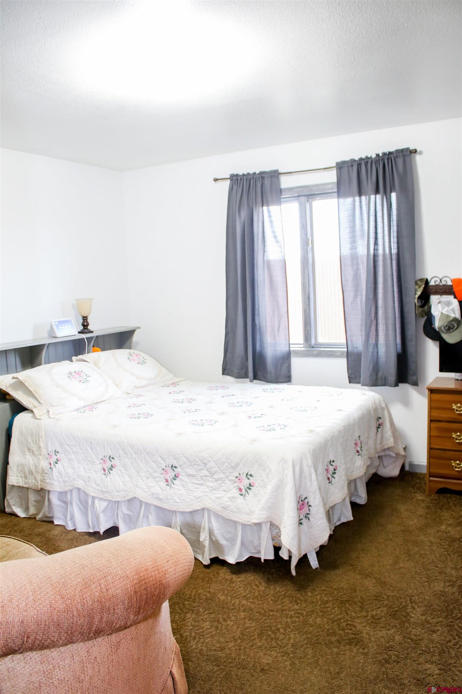 58811 Banner Road Olathe, CO 81425 - Photo 21 of 35 a bedroom with bed and window