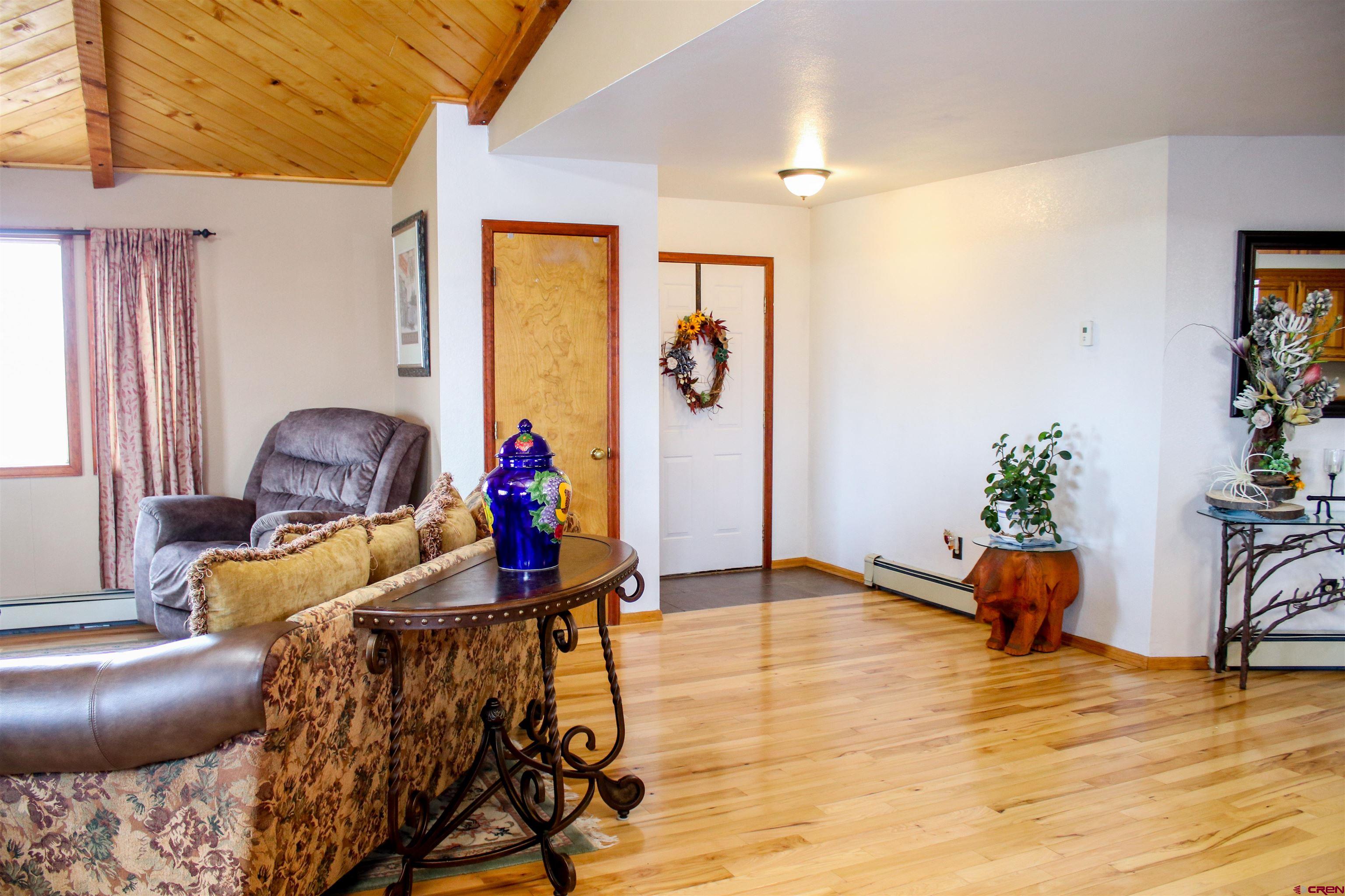 58811 Banner Road Olathe, CO 81425 - Photo 8 of 35 a living room with furniture and a potted plant