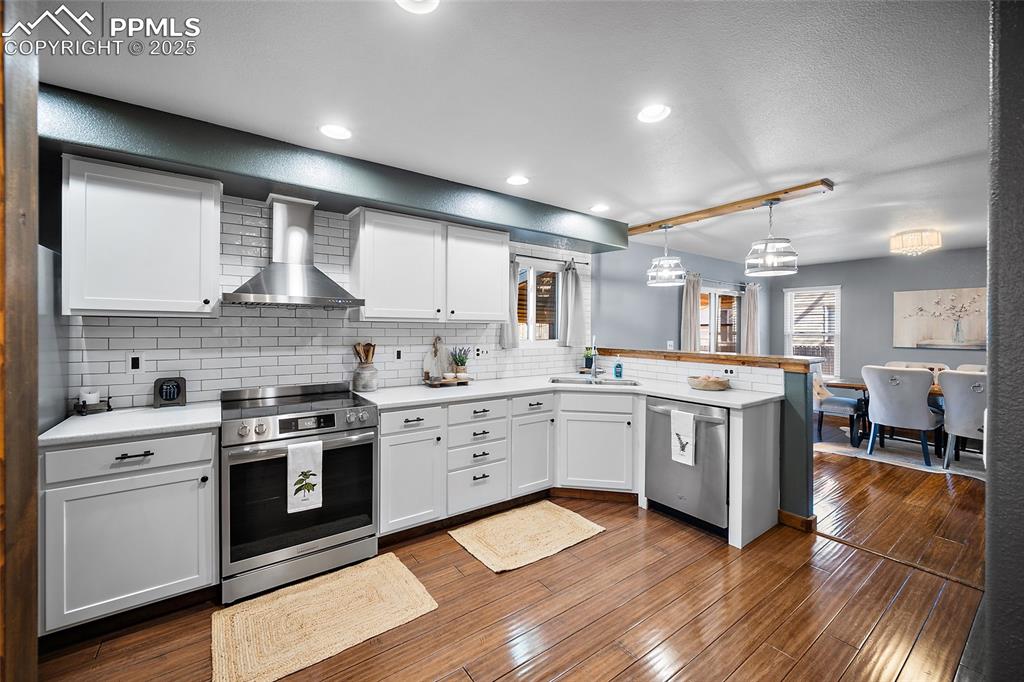 7015 Reunion Circle Fountain, CO 80817 - Photo 11 of 41 a kitchen with a sink stove and cabinets