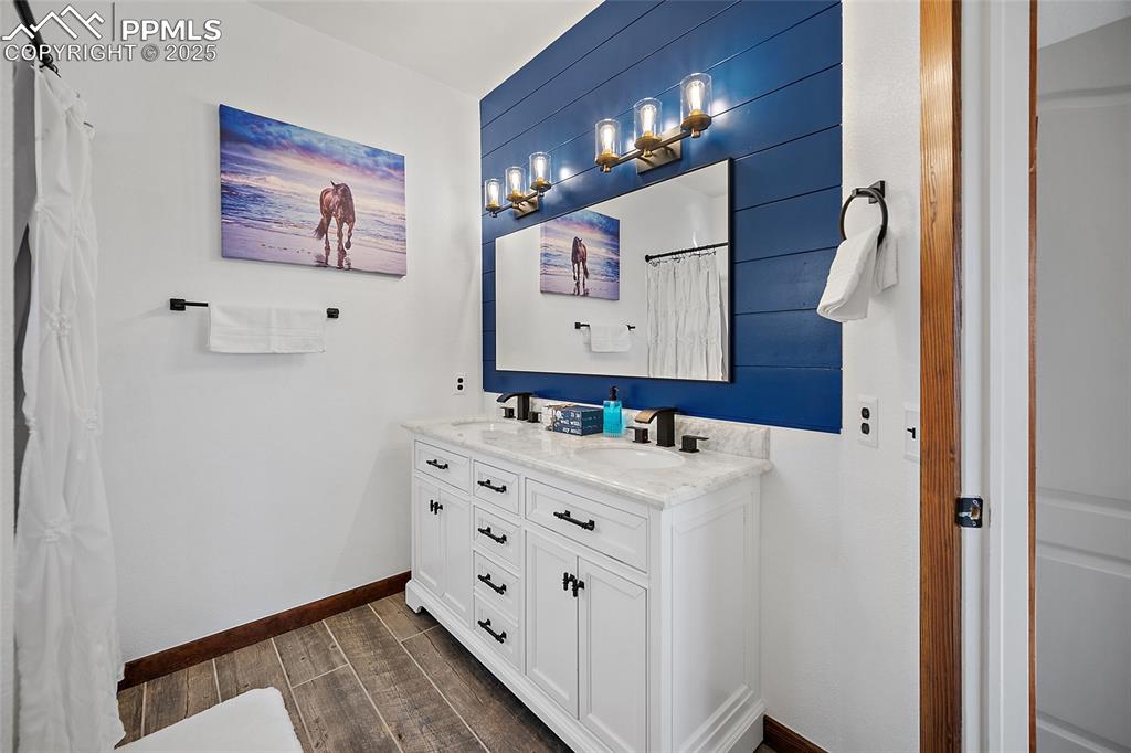 7015 Reunion Circle Fountain, CO 80817 - Photo 14 of 41 a bathroom with a sink a mirror and a shower
