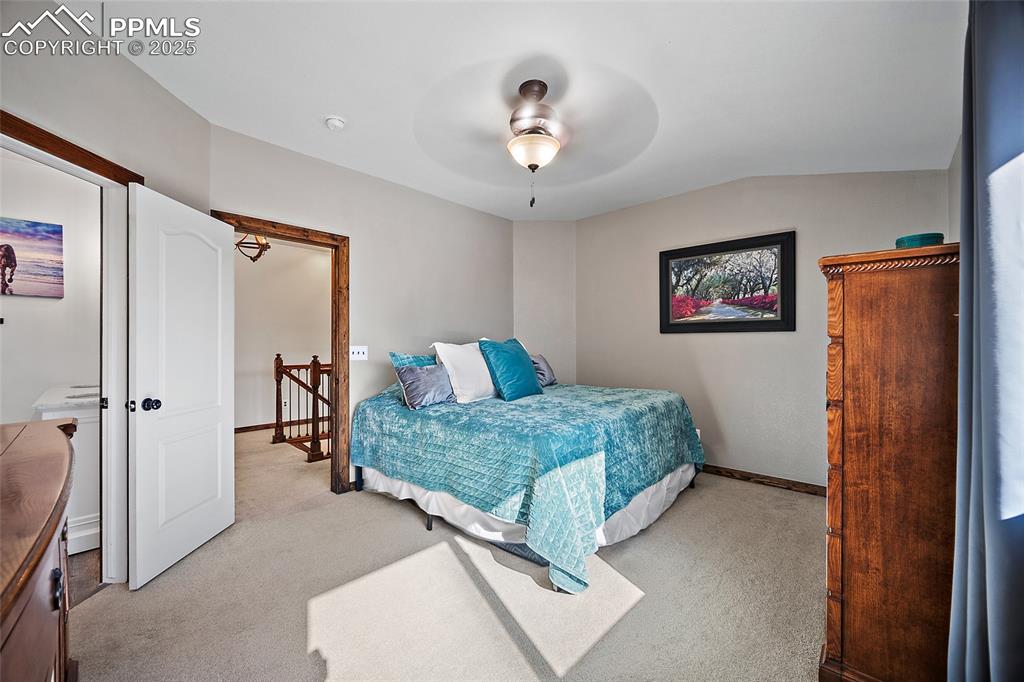 7015 Reunion Circle Fountain, CO 80817 - Photo 16 of 41 a room that has a bed and a chandelier in it