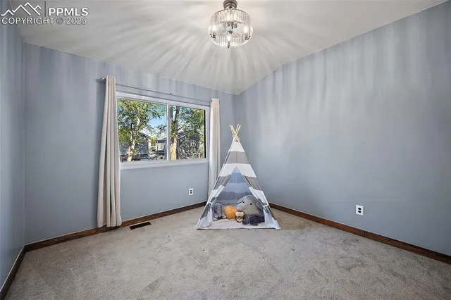 a room with a window and a chandelier