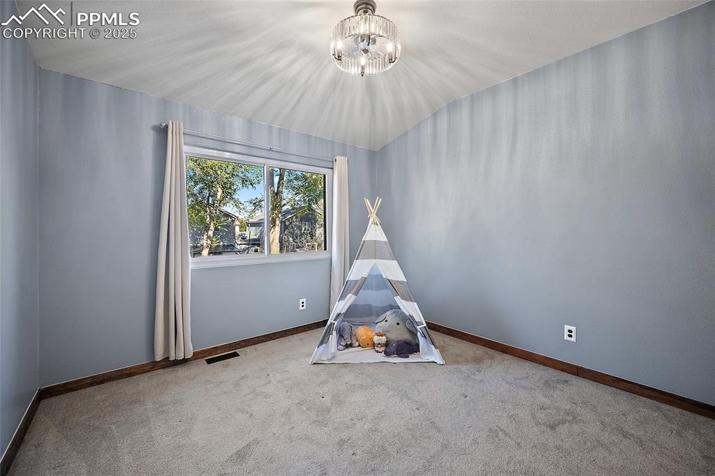 7015 Reunion Circle Fountain, CO 80817 - Photo 19 of 41 a room with a window and a chandelier