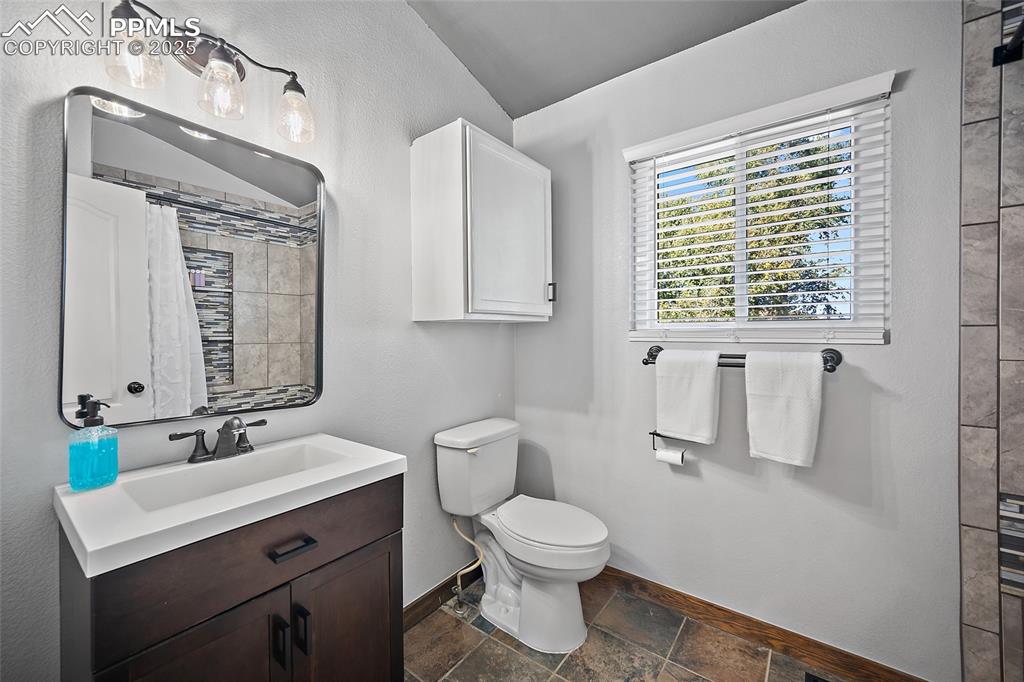7015 Reunion Circle Fountain, CO 80817 - Photo 20 of 41 a bathroom with a toilet sink and mirror