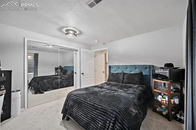 a bedroom with a bed and a mirror