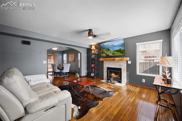 a living room with furniture fireplace and window