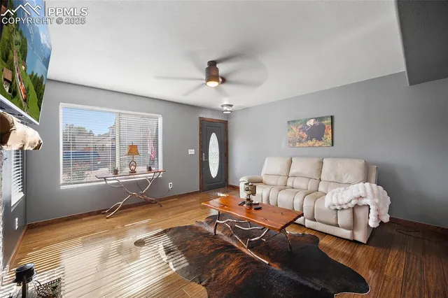 a bedroom with furniture and a large window
