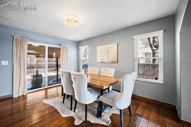a dining room with furniture and wooden floor